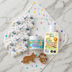 Maaiee Ayurvedic newborn care set with cow ghee massage oil, diaper cream, hooded towel and nappy