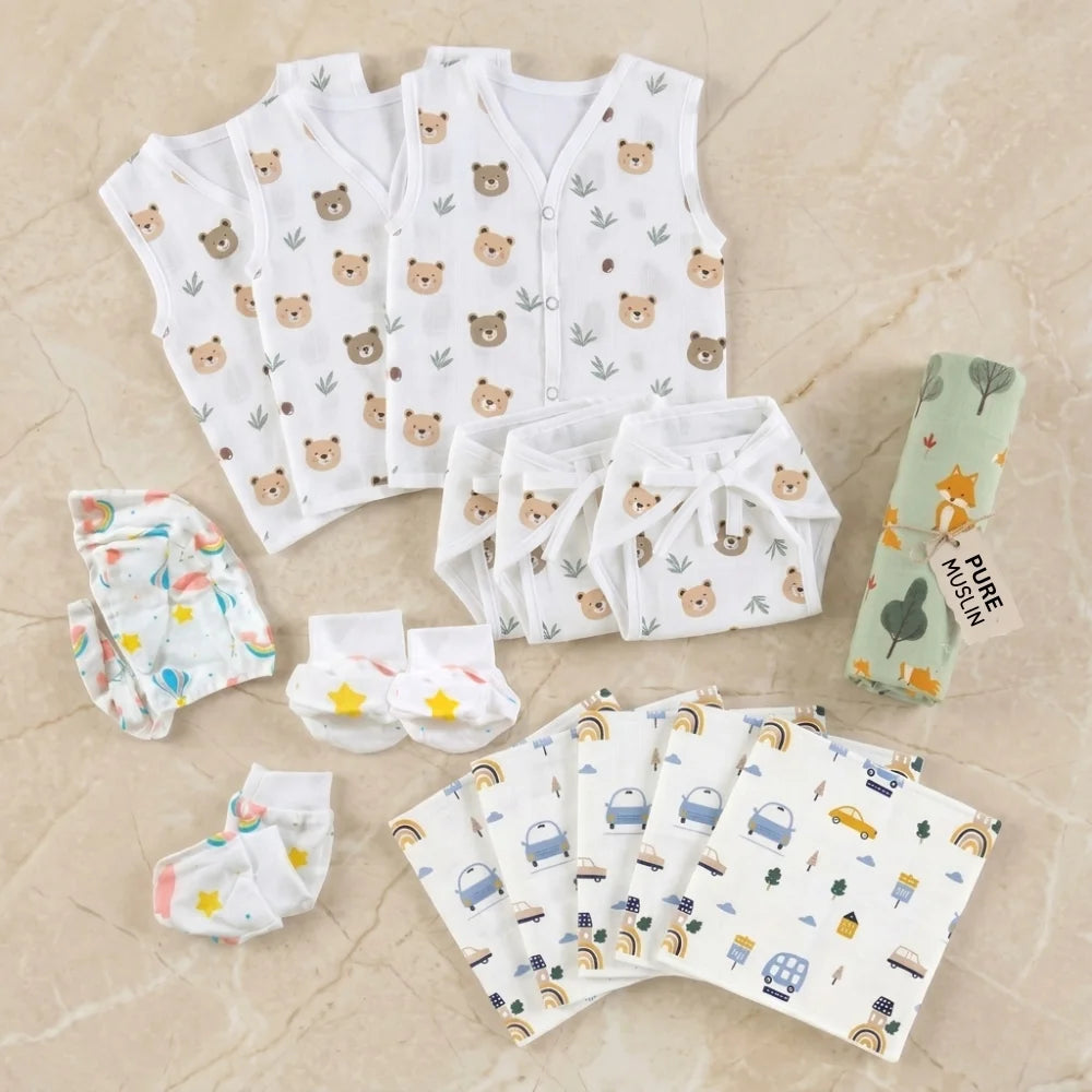 13-piece muslin newborn essentials kit featuring 3 jablas, 3 nappies, 1 muslin swaddle, 1 cap-mitten-booty set and reusable wipes.