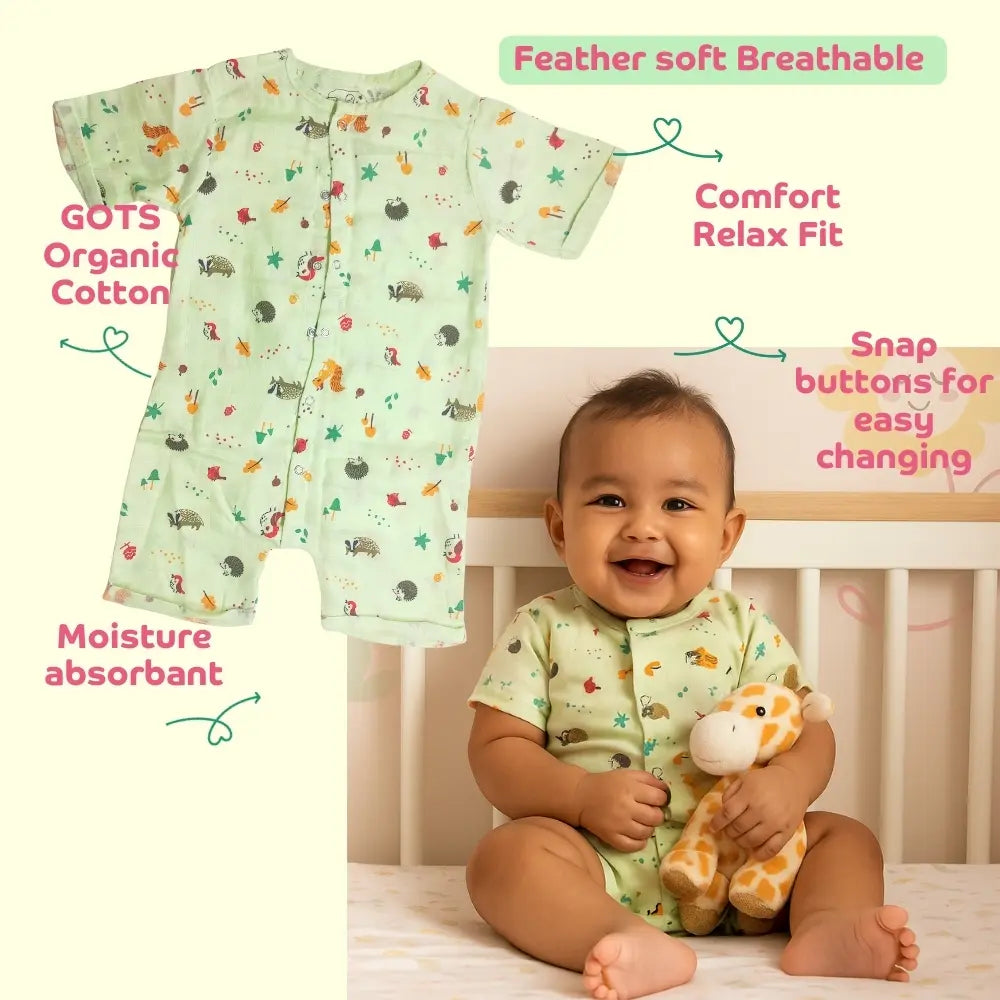 Smiling baby wearing a Maaiee organic cotton romper green with soft breathable fabric features.