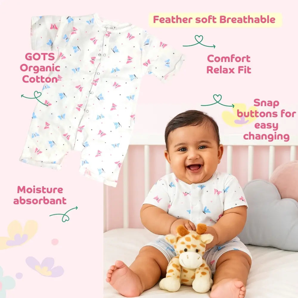 Smiling baby wearing a Maaiee organic cotton romper white with soft breathable fabric features.